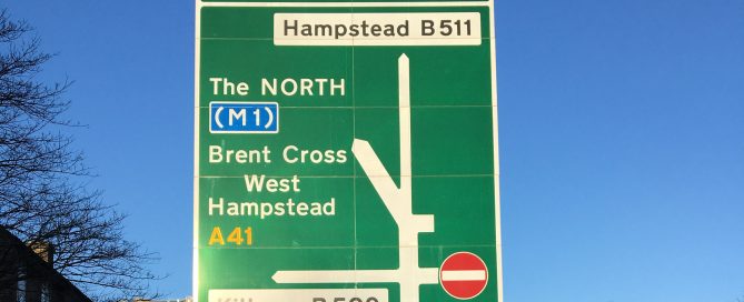 Swizz Cottage Road Sign show A Roads, B Roads & Motorway